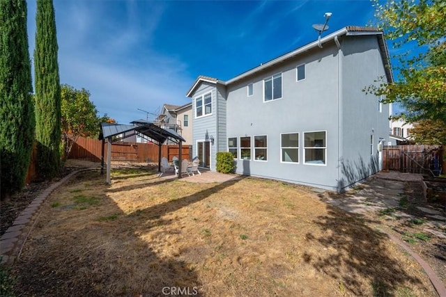 rear view of property with a gazebo