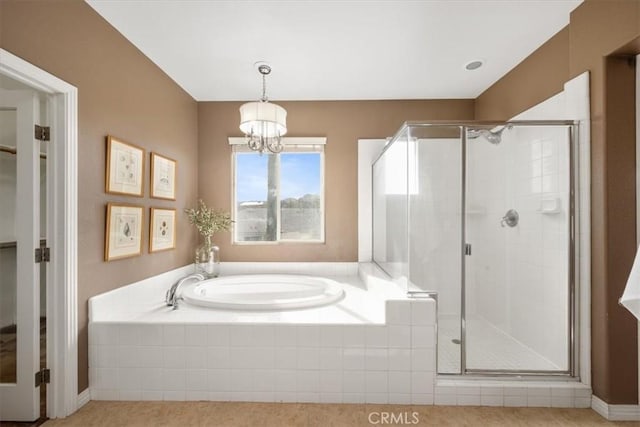 bathroom featuring plus walk in shower and a chandelier