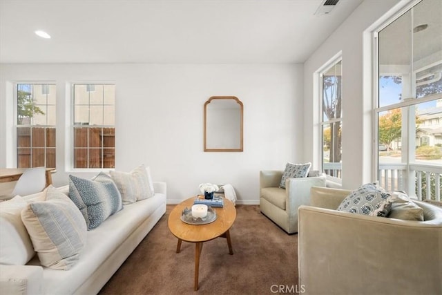 living room with plenty of natural light and carpet floors