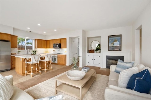 living room with light tile patterned floors and sink