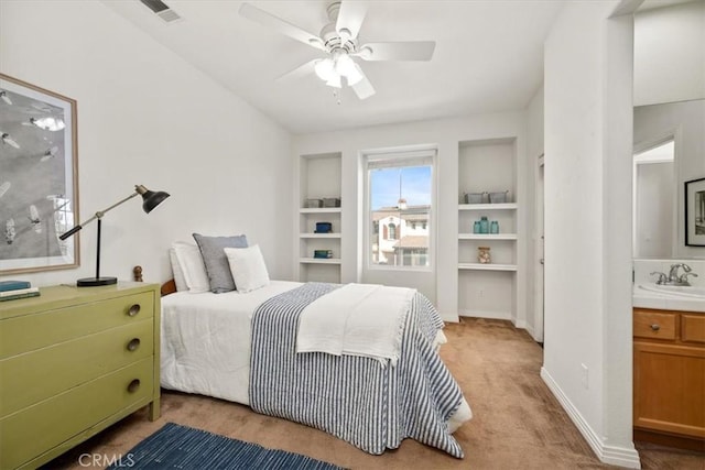 carpeted bedroom featuring ceiling fan and sink