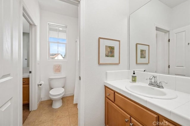 bathroom with tile patterned floors, vanity, and toilet