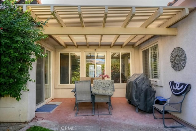 view of patio with a grill and a pergola