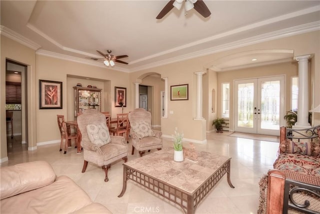 living room featuring ceiling fan, decorative columns, and french doors