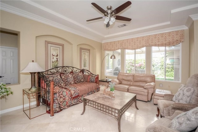 living room featuring ceiling fan, light tile patterned flooring, a raised ceiling, and crown molding