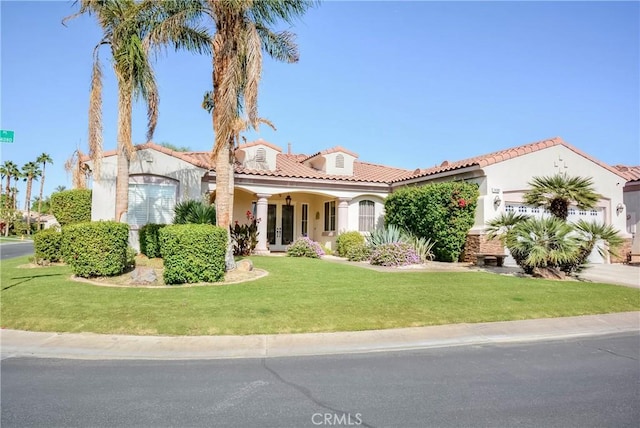 mediterranean / spanish-style home featuring a front lawn