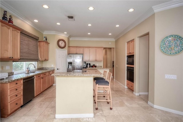 kitchen with a center island, sink, light stone counters, black appliances, and ornamental molding