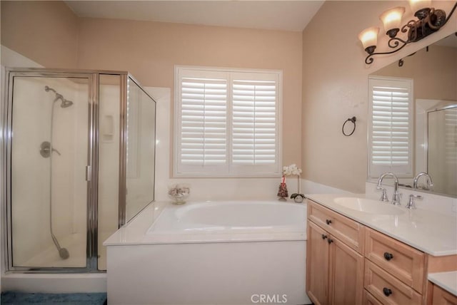 bathroom featuring plus walk in shower and vanity