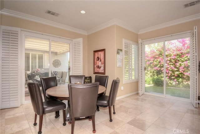 dining space featuring crown molding