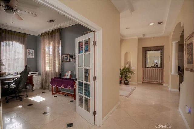 home office featuring decorative columns, ceiling fan, french doors, and ornamental molding