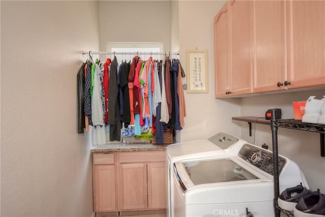 washroom with washer and clothes dryer and cabinets