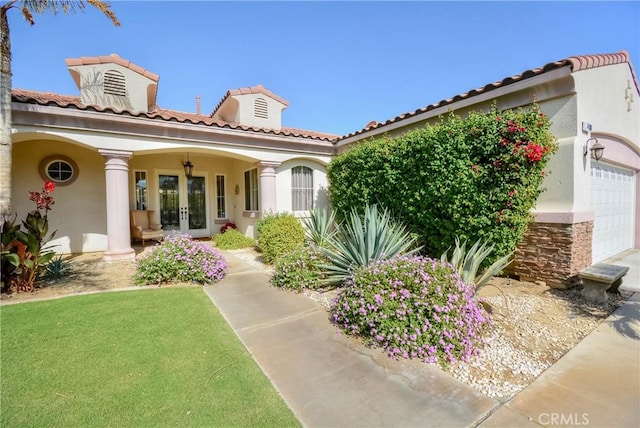 view of front of property with french doors and a garage