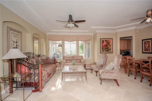 living room featuring ceiling fan and ornamental molding