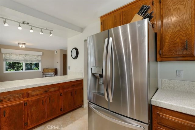 kitchen featuring stainless steel refrigerator with ice dispenser