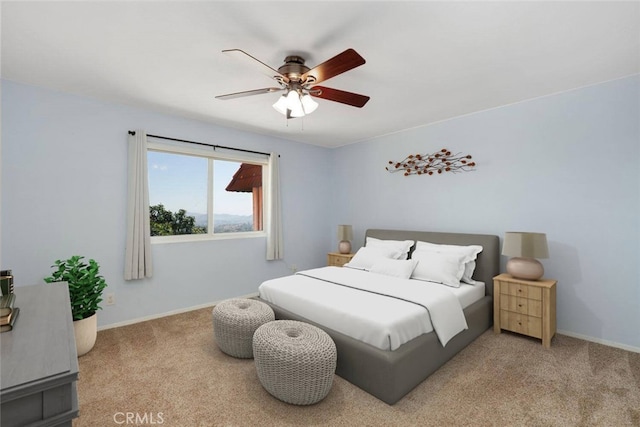 bedroom with ceiling fan and light colored carpet