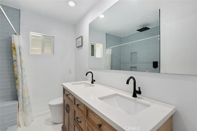 bathroom featuring tile patterned floors, vanity, toilet, and walk in shower