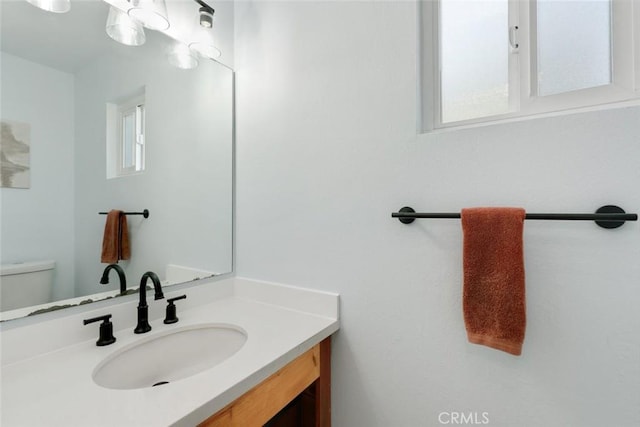 bathroom with vanity and toilet