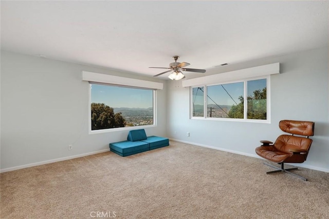 sitting room with light carpet and ceiling fan