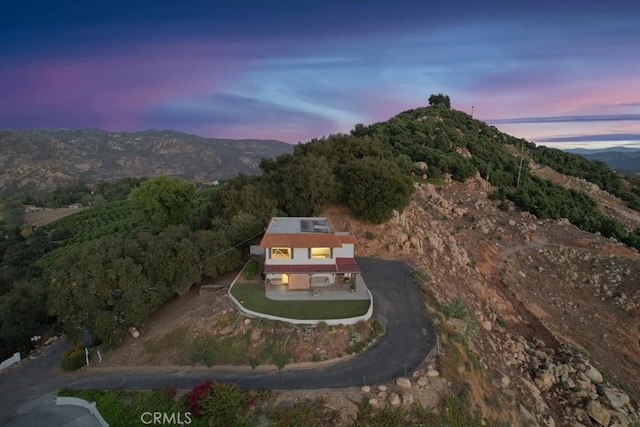 aerial view at dusk featuring a mountain view