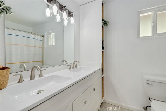 bathroom with tile patterned floors, vanity, and toilet