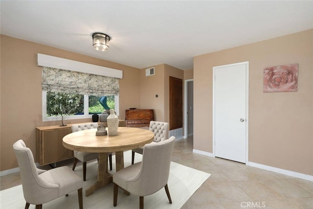 dining space featuring light tile patterned floors