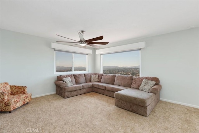 carpeted living room featuring ceiling fan