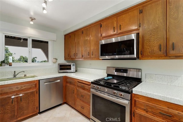 kitchen with sink and appliances with stainless steel finishes