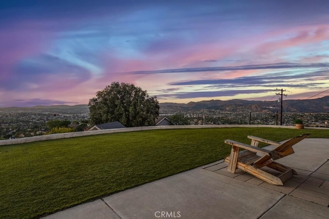 exterior space featuring a lawn and a mountain view