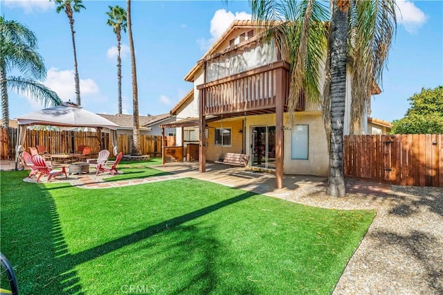 back of property featuring a fenced backyard, a patio, a lawn, and stucco siding