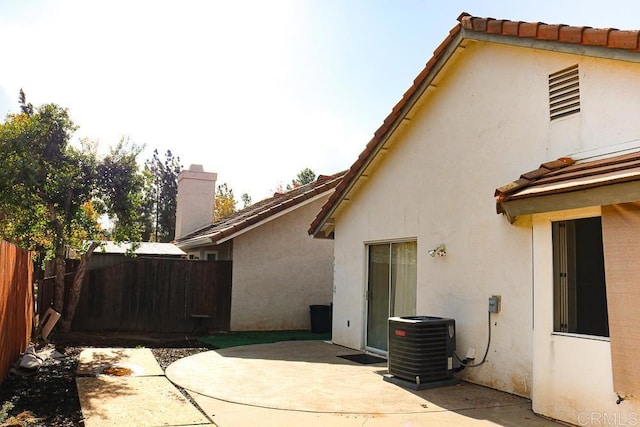 back of house with a patio and central AC