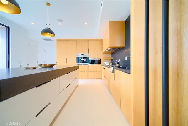 kitchen featuring light brown cabinetry, oven, decorative light fixtures, and tasteful backsplash