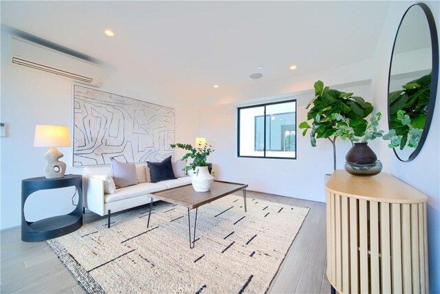 living room with wood-type flooring and a wall mounted air conditioner