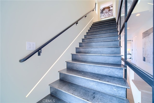 stairway with hardwood / wood-style floors