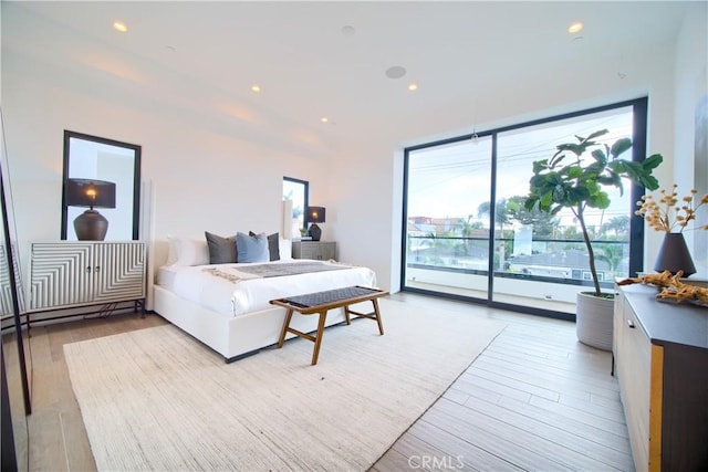 bedroom featuring recessed lighting, access to outside, and wood finished floors
