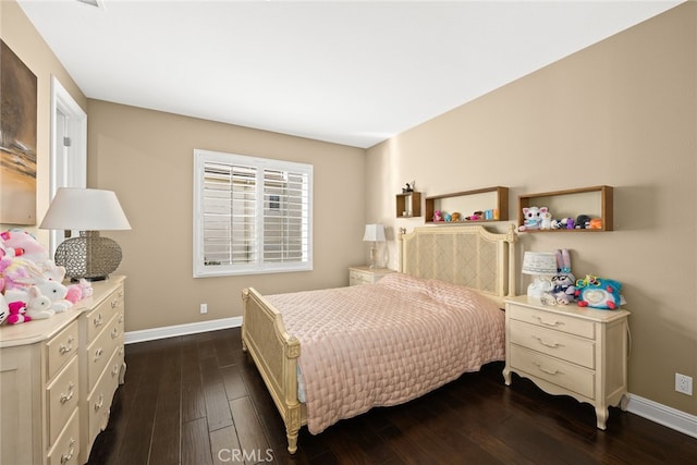 bedroom with dark hardwood / wood-style floors