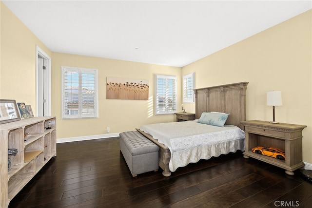 bedroom with dark hardwood / wood-style floors