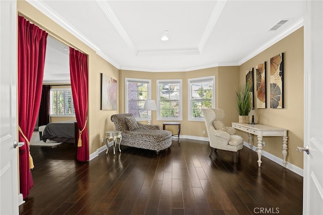 sitting room with crown molding, a tray ceiling, and dark hardwood / wood-style flooring