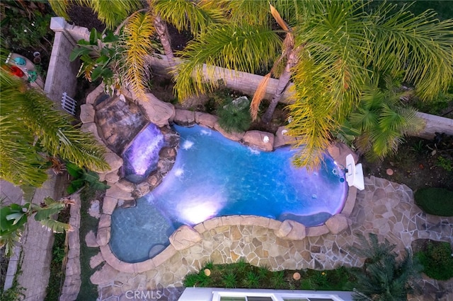 view of swimming pool with a hot tub