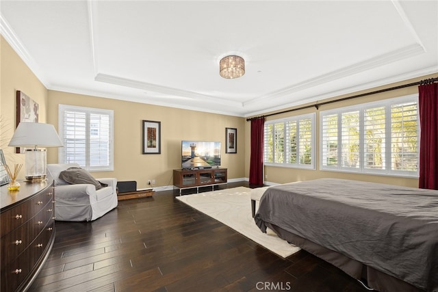 bedroom with crown molding, multiple windows, a tray ceiling, and dark hardwood / wood-style flooring