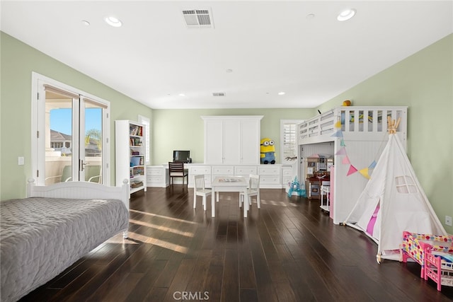 bedroom with dark hardwood / wood-style floors and access to exterior