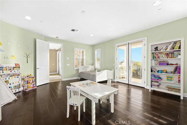 bedroom with multiple windows, access to outside, and dark hardwood / wood-style flooring