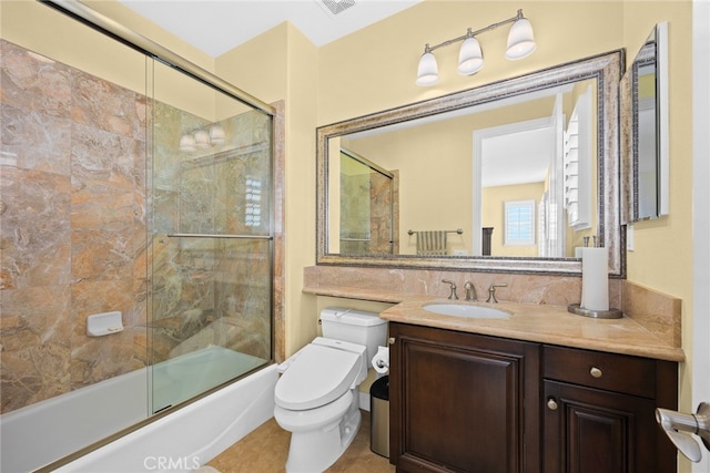 full bathroom featuring vanity, toilet, tile patterned floors, and shower / bath combination with glass door