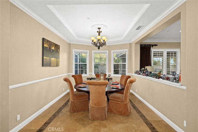 dining room with a chandelier, crown molding, a tray ceiling, and plenty of natural light