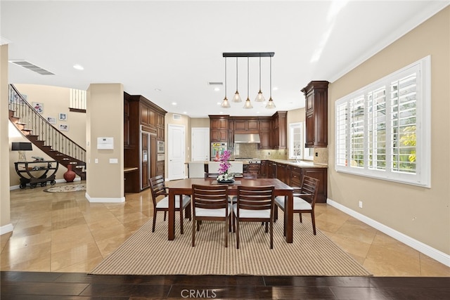 tiled dining room with crown molding