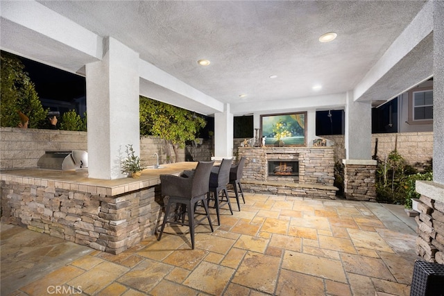 view of patio / terrace featuring an outdoor bar, exterior kitchen, and grilling area