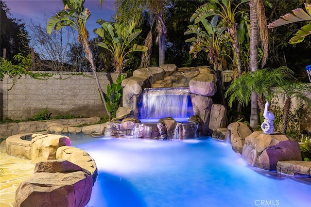 view of pool at dusk