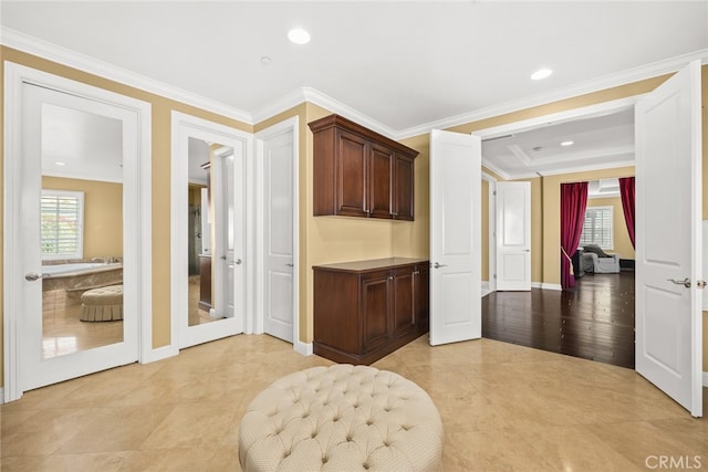 kitchen featuring light hardwood / wood-style flooring, dark brown cabinetry, and crown molding