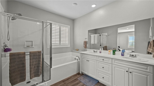 bathroom featuring vanity, separate shower and tub, and hardwood / wood-style floors