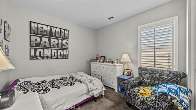 carpeted bedroom featuring multiple windows