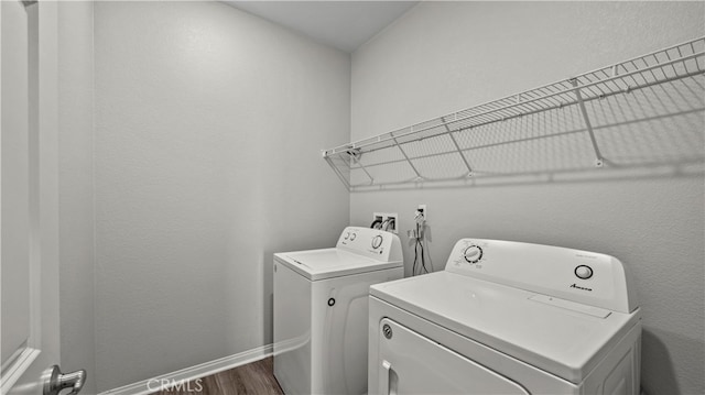 laundry area featuring washer and clothes dryer and dark hardwood / wood-style flooring